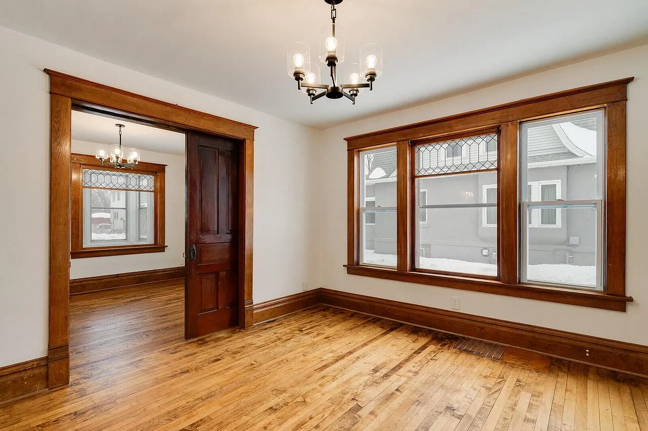 Restored living room with original hardwood floors and woodwork