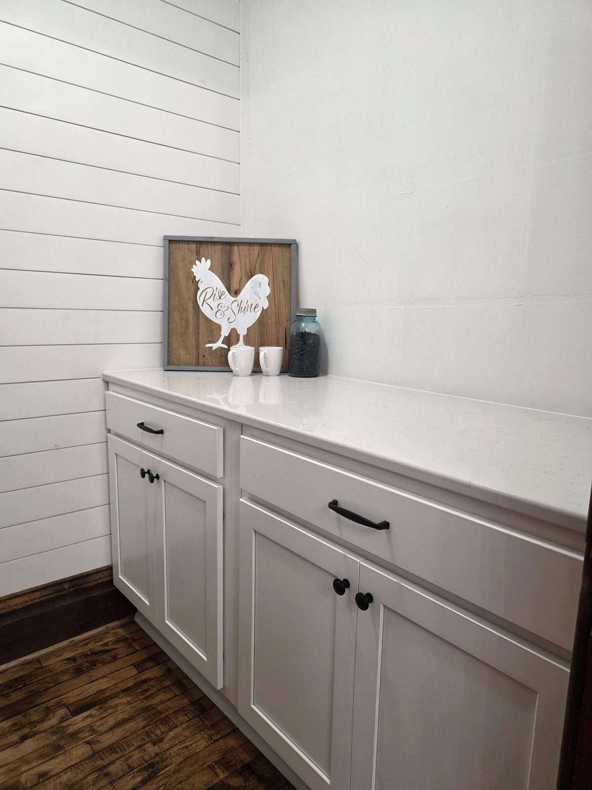 Farmhouse kitchen remodel with white shaker cabinets and hardwood floors